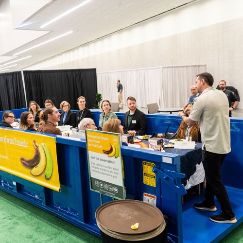 Attendees at WasteExpo holding reusable cups