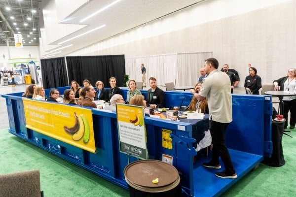 3 WasteExpo attendees having a conversation in a conference room