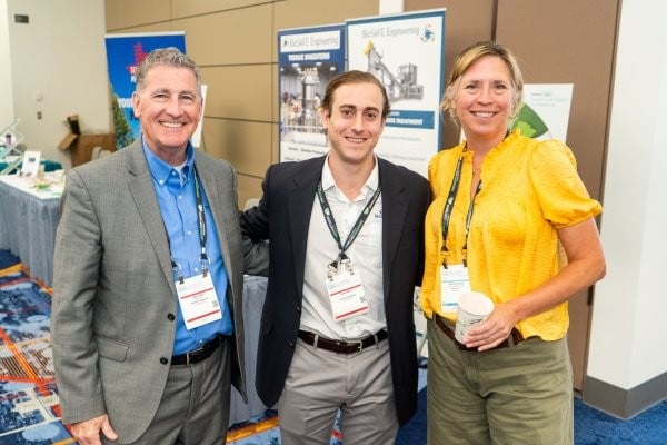 Group of attendees hacing a conversation on the WasteExpo show floor
