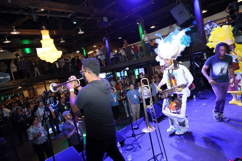 Band perfoming on a lit stage at the WasteExpo Welcome Party