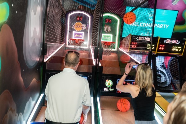 2 people playing each other on a basketball arcade game at the WasteExpo Welcome Reception