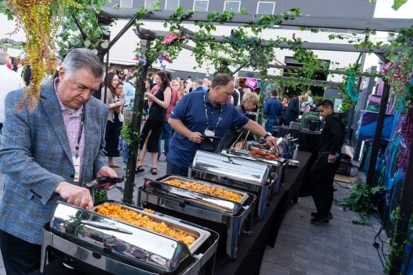 People grabbing food from the buffet bar at the WasteExpo Welcome Reception