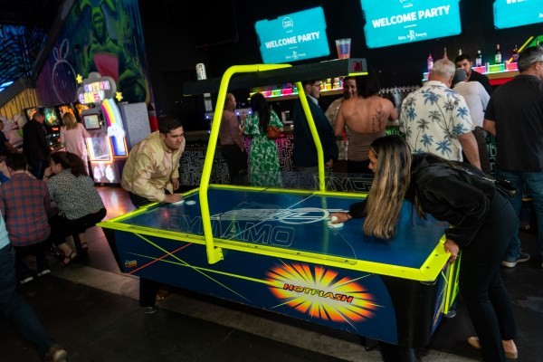 2 people playing against each other in air hockey at the WasteExpo Welcome Reception