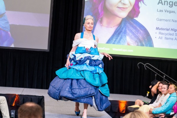 Women walking in dress down runway at Trashion
