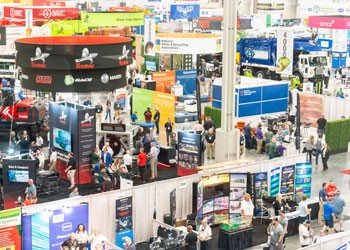 Exhibitor booth with waste trucks on the WasteExpo show floor